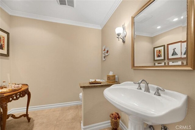 half bathroom featuring visible vents, ornamental molding, tile patterned flooring, toilet, and a sink