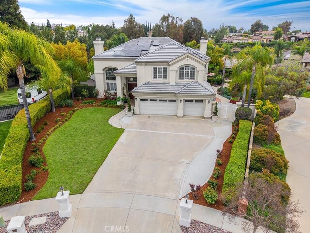 view of front of house featuring fence, a front lawn, a garage, a chimney, and concrete driveway
