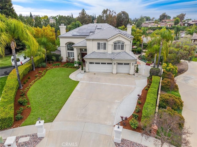 748 E Mariposa Dr, Redlands, CA 92373 - traditional-style house featuring a chimney, a garage, concrete driveway, stucco siding, and a tile roof