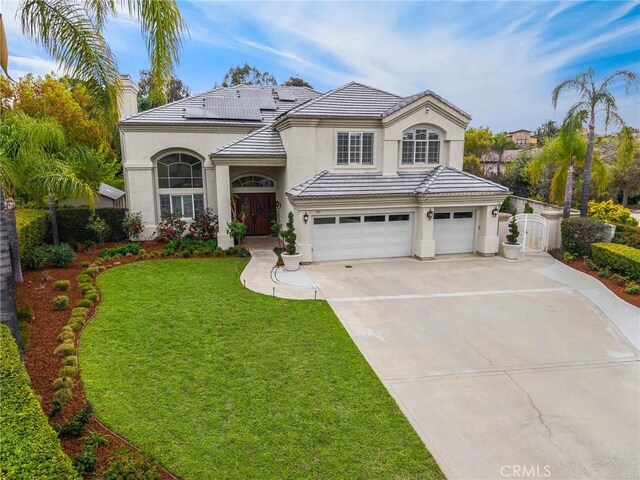 view of front of property with an attached garage, stucco siding, concrete driveway, and a front yard