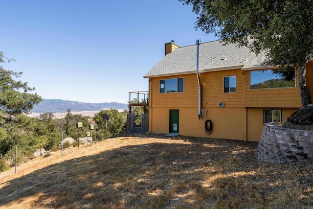 25770 E Grade Rd, Santa Ysabel, CA 92070 - back of house featuring a chimney, a mountain view, and roof with shingles