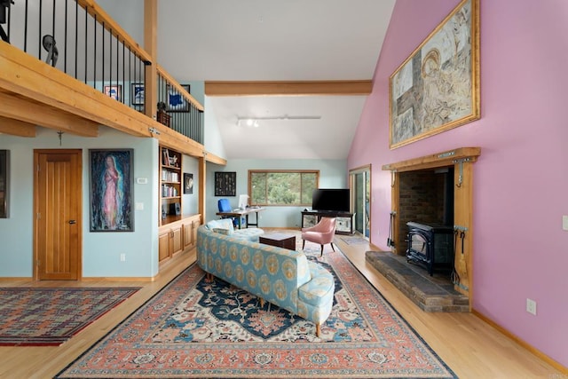 25770 E Grade Rd, Santa Ysabel, CA 92070 - living area with wood finished floors, a wood stove, and high vaulted ceiling