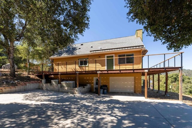 25770 E Grade Rd, Santa Ysabel, CA 92070 - view of front facade featuring driveway, a garage, a deck, a chimney, and roof with shingles
