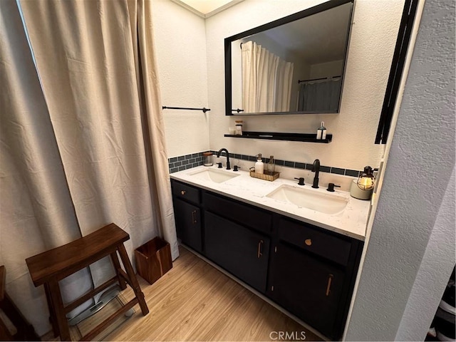 1497 Chaparral Way, Oceanside, CA 92057 - bathroom featuring wood finished floors, backsplash, double vanity, and a textured wall