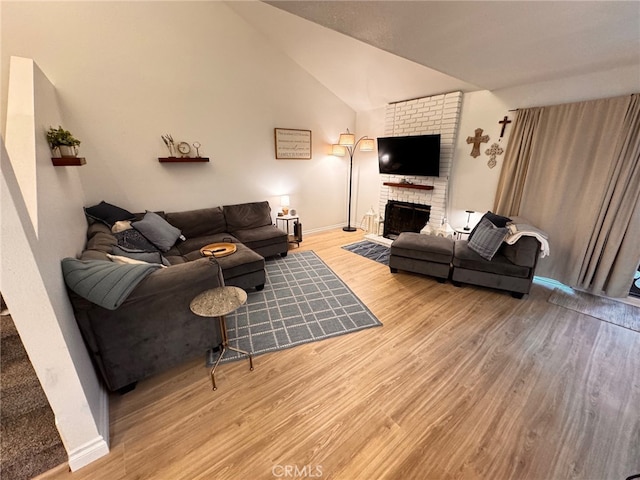 1497 Chaparral Way, Oceanside, CA 92057 - living area featuring light wood-style flooring, a brick fireplace, baseboards, and lofted ceiling