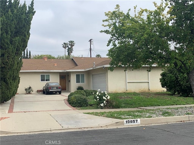 19057 Gledhill St, Northridge, CA 91324 - ranch-style house featuring stucco siding, an attached garage, and concrete driveway