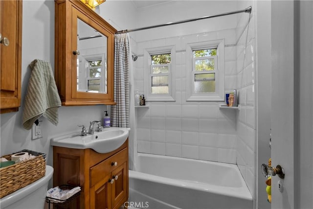 full bath featuring shower / bathtub combination with curtain, toilet, and vanity