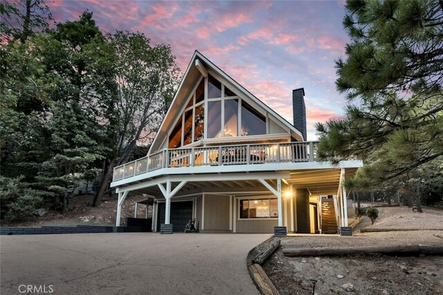 675 Grass Valley Rd, Lake Arrowhead, CA 92352 - chalet / cabin featuring a deck, driveway, and a chimney