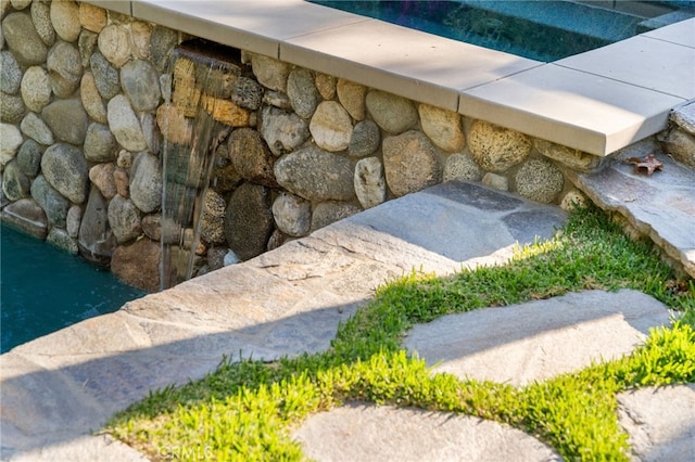 exterior details featuring a swimming pool