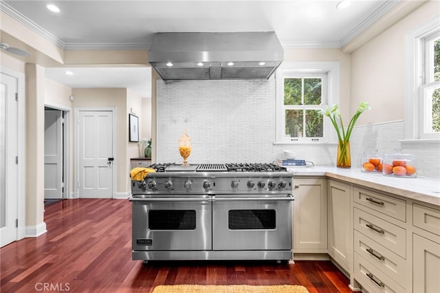 kitchen with ornamental molding, ventilation hood, tasteful backsplash, range with two ovens, and dark wood finished floors