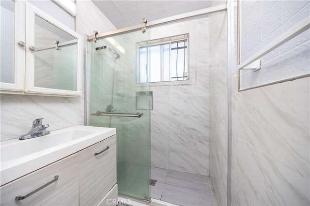 bathroom with vanity and a stall shower