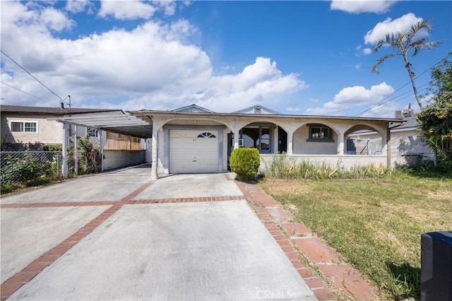 ranch-style home with covered porch, concrete driveway, fence, an attached garage, and a front yard