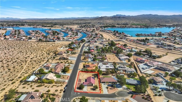 birds eye view of property featuring a water and mountain view