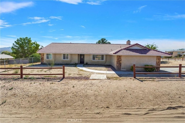 single story home featuring fence, a tile roof, stucco siding, and a chimney