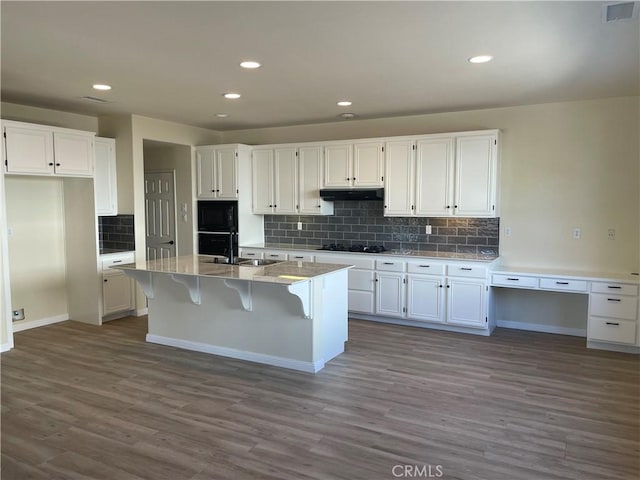 32706 Blue Mist Way, Wildomar, CA 92595 - kitchen with a sink, white cabinetry, under cabinet range hood, dark wood-type flooring, and visible vents