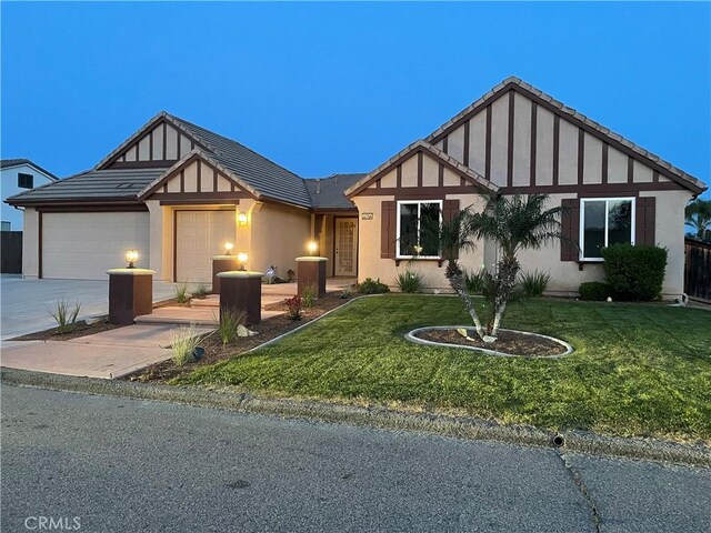 32706 Blue Mist Way, Wildomar, CA 92595 - tudor home with stucco siding, a front lawn, driveway, and a garage