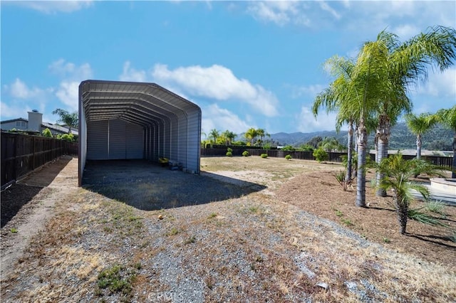 32706 Blue Mist Way, Wildomar, CA 92595 - garage featuring fence, a carport, driveway, and a mountain view