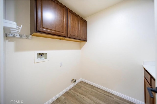 32706 Blue Mist Way, Wildomar, CA 92595 - clothes washing area with baseboards, light wood-style floors, washer hookup, and cabinet space