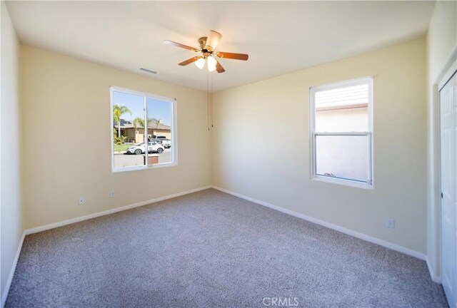 32706 Blue Mist Way, Wildomar, CA 92595 - carpeted spare room featuring a wealth of natural light, a ceiling fan, visible vents, and baseboards