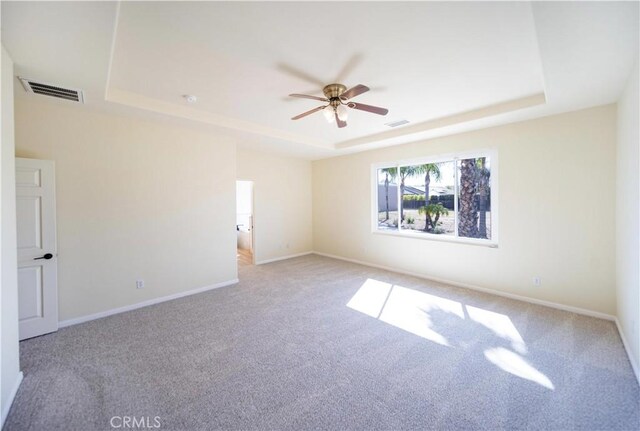 32706 Blue Mist Way, Wildomar, CA 92595 - spare room featuring a tray ceiling, carpet, visible vents, and a ceiling fan