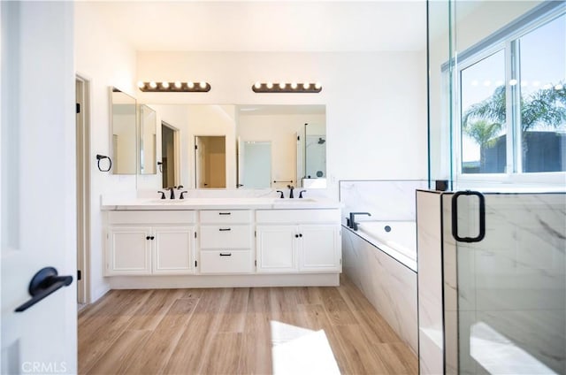 32706 Blue Mist Way, Wildomar, CA 92595 - bathroom featuring a garden tub, wood finished floors, a sink, and a stall shower