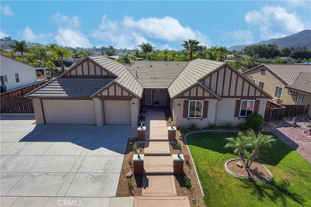 32706 Blue Mist Way, Wildomar, CA 92595 - english style home with a mountain view, concrete driveway, fence, a garage, and a front yard