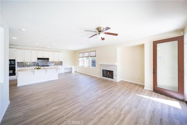 32706 Blue Mist Way, Wildomar, CA 92595 - unfurnished living room with light wood-type flooring, a ceiling fan, baseboards, and recessed lighting