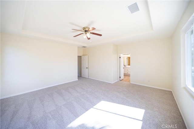 32706 Blue Mist Way, Wildomar, CA 92595 - unfurnished room with a raised ceiling, visible vents, baseboards, light colored carpet, and ceiling fan