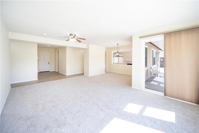 32706 Blue Mist Way, Wildomar, CA 92595 - unfurnished living room featuring carpet flooring, baseboards, and ceiling fan with notable chandelier