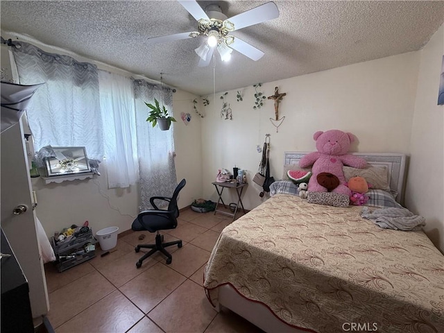 105 Orange Ave, Chowchilla, CA 93610 - bedroom with light tile patterned floors, a ceiling fan, and a textured ceiling