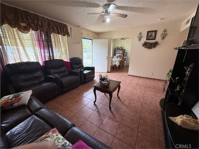 105 Orange Ave, Chowchilla, CA 93610 - tiled living area featuring a ceiling fan and a textured ceiling