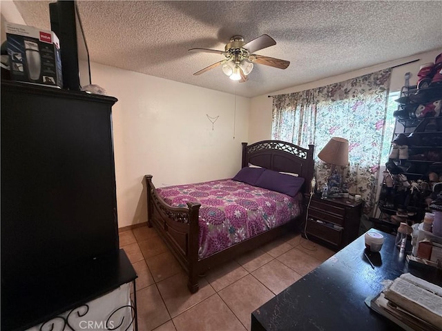 105 Orange Ave, Chowchilla, CA 93610 - bedroom with light tile patterned floors, a textured ceiling, and ceiling fan