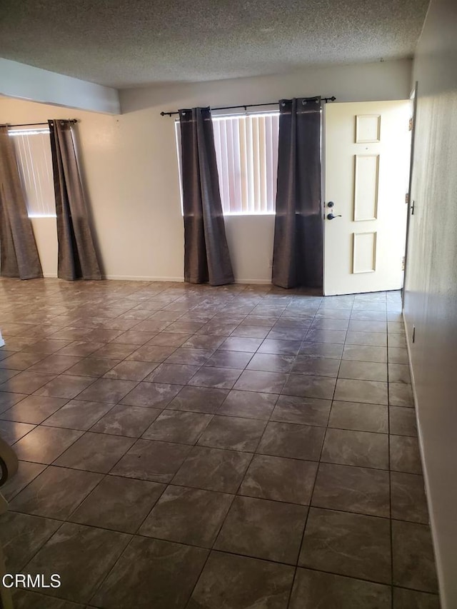 2587 Rudder Ave, Port Hueneme, CA 93041 - empty room with a textured ceiling and dark tile patterned floors