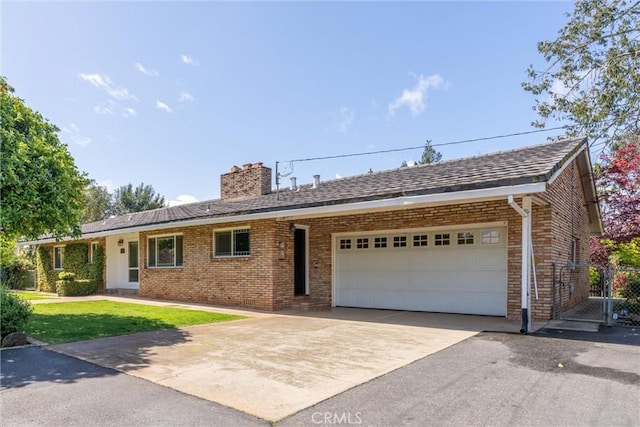 ranch-style home featuring concrete driveway, a front lawn, brick siding, a garage, and a chimney