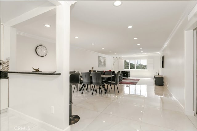 dining area with baseboards, crown molding, tile patterned flooring, and recessed lighting