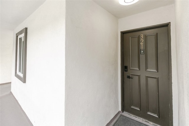 property entrance featuring stucco siding