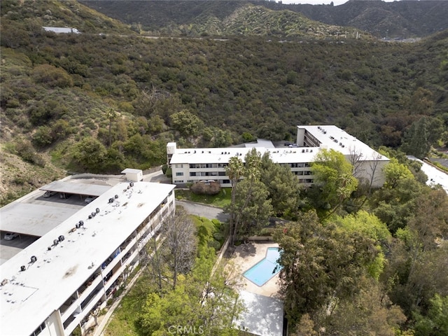 aerial view featuring a mountain view and a view of trees