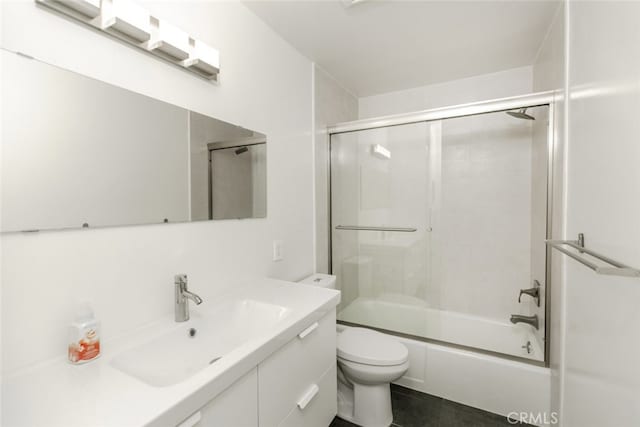 bathroom with enclosed tub / shower combo, toilet, and vanity