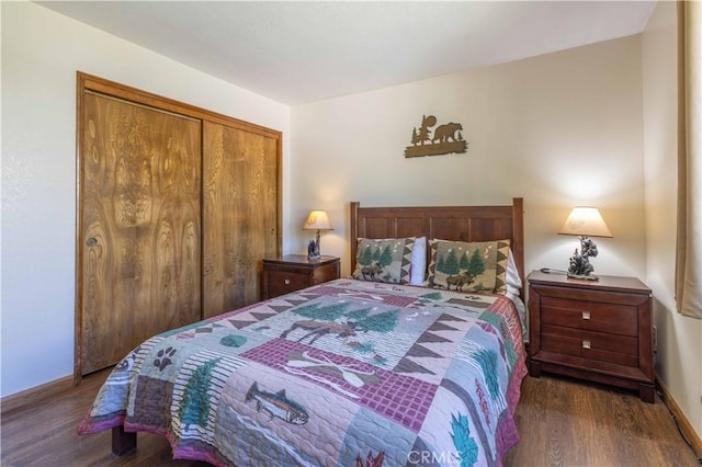 bedroom with baseboards, a closet, and wood finished floors
