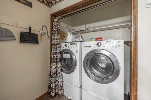 clothes washing area featuring washing machine and clothes dryer and laundry area