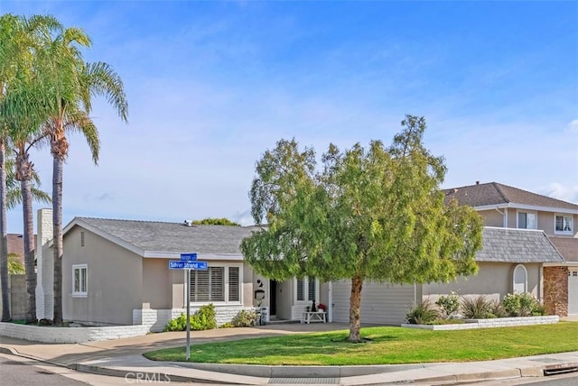9871 Silver Strand Dr, Huntington Beach, CA 92646 - view of front of house with stucco siding and a front lawn