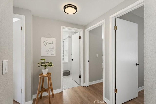 9871 Silver Strand Dr, Huntington Beach, CA 92646 - corridor featuring baseboards and wood finished floors