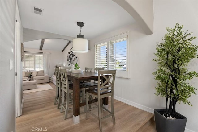 9871 Silver Strand Dr, Huntington Beach, CA 92646 - dining area with arched walkways, visible vents, beam ceiling, and light wood finished floors