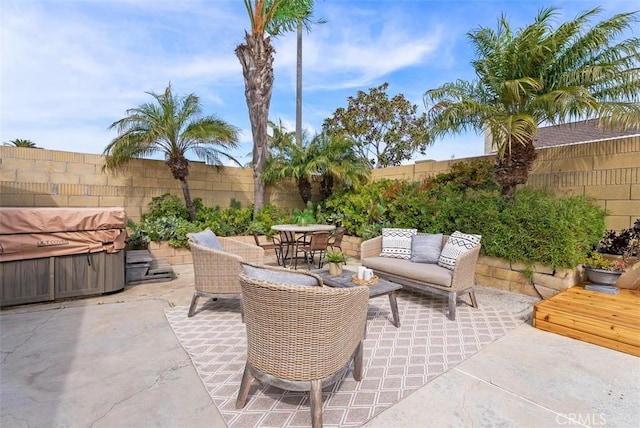 9871 Silver Strand Dr, Huntington Beach, CA 92646 - view of patio / terrace with outdoor lounge area, a hot tub, a fenced backyard, and outdoor dining space