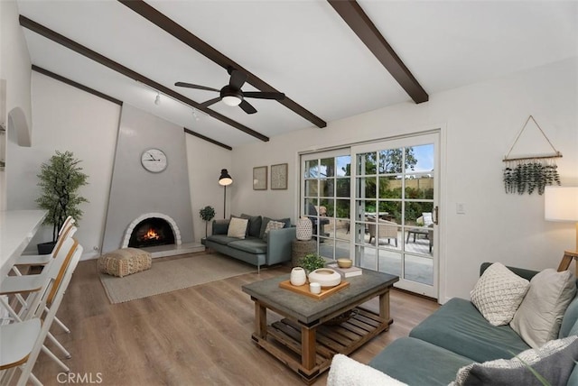 9871 Silver Strand Dr, Huntington Beach, CA 92646 - living room with vaulted ceiling with beams, wood finished floors, a large fireplace, and ceiling fan