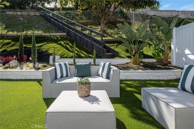 view of home's community with an outdoor hangout area, fence, and a yard