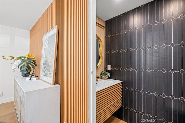 bathroom with wood finished floors and vanity