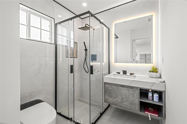bathroom with toilet, vanity, recessed lighting, and a shower stall