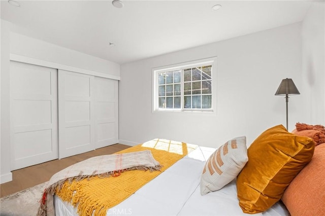 bedroom with baseboards and a closet