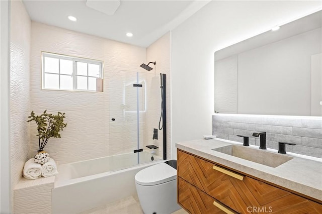 bathroom with vanity, recessed lighting, toilet, decorative backsplash, and shower / washtub combination